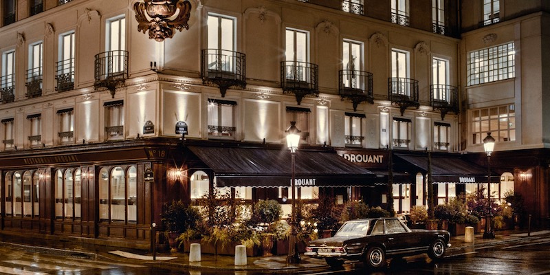 A calssic Mercedes sports car parked outside of historic Paris bistro Drouant