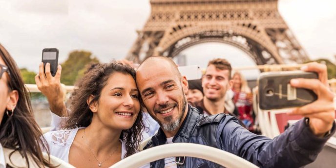 A couple taking a selfie on an Open Air Bus Tour