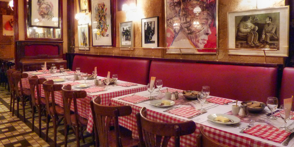 Tables at Chez Denise covered with red and white checked tablecloths