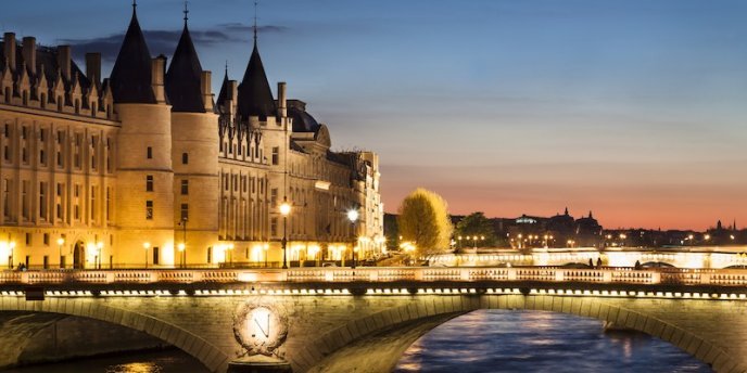 La Conciergerie at night, with the river Seine in the foreground