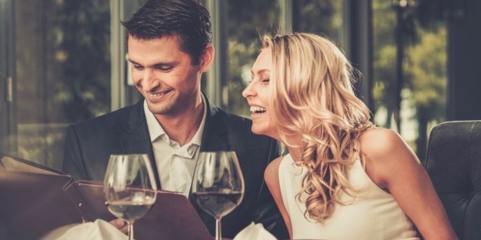 A well-dressed couple enjoying a dinner at Madame Brasserie on the Eiffel Tower