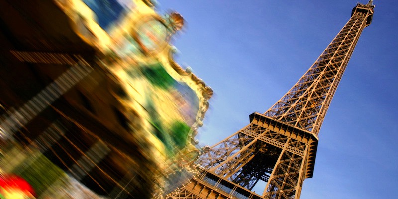 The spinning carosel at the Eiffel Tower creates a blur