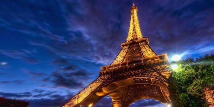 The Eiffel Tower looking golden and grand at night