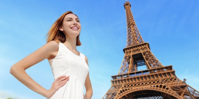 A young woman visitor to Paris at the Eiffel Tower