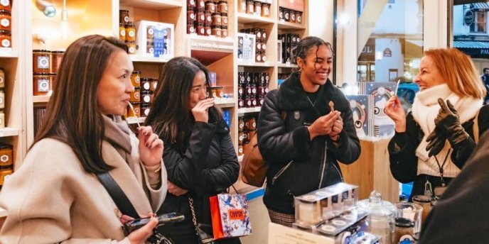 A group of women visitors enjoy themselves in a choclate store on a Paris Chocolate and Pastry Tour