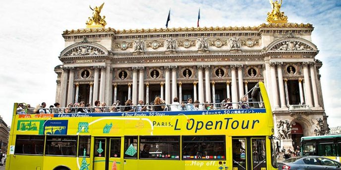 A Hop-On-Hop-Off Bus passing in fronot of Palais Garnier