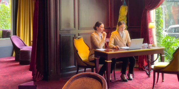 Two women check-in clerks at hotel Barrière Fouquet's Paris