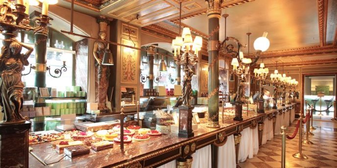 Brass fittings and warm lighting inside a classic Laduree location