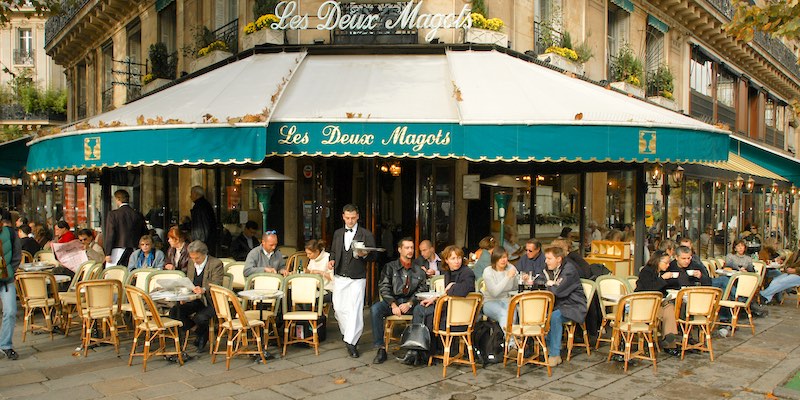 Diners on the sidewalk in front of cafe Les Deux Magots in the 6th Arrondissement