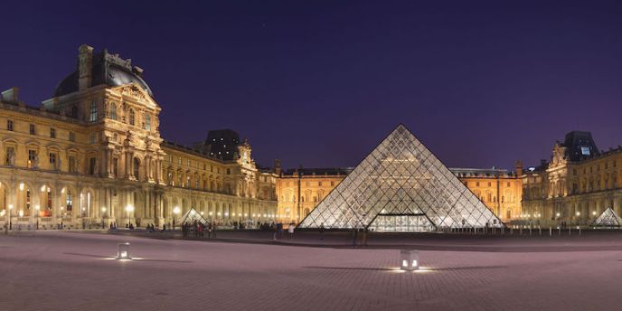 The Louvre courtyard at night, with the Pyramid