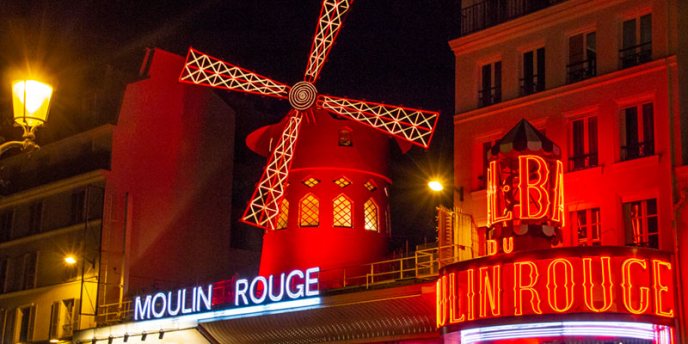 The iconic red windmill at Moulin Rouge Paris