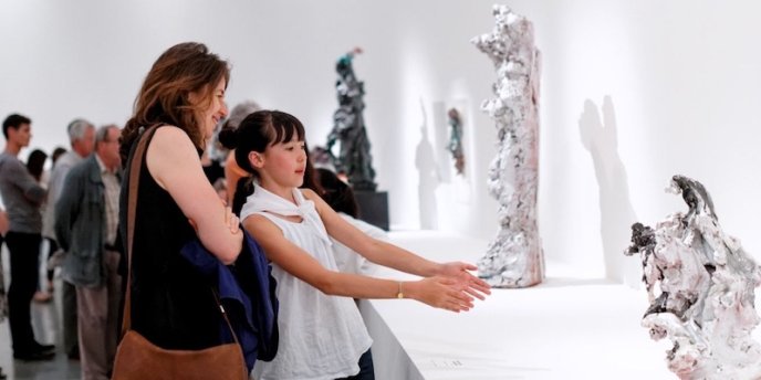 FA mother and daughter examine a scullpture at the Museum of Modern Art in Paris