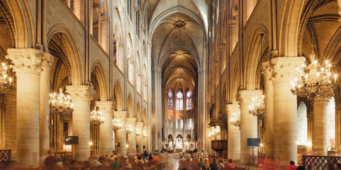 A golden view of the interior of Notre Dame and its high arches during an Easter service