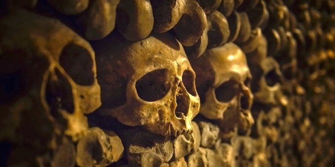 Human skulls form a wall in the Paris Catacombs, located in the 14th Arrondissement