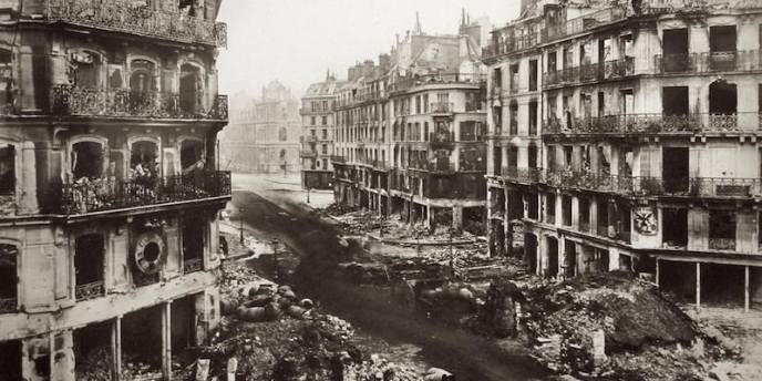 Rubble fills the streets among damaged buildings during the Paris Commune