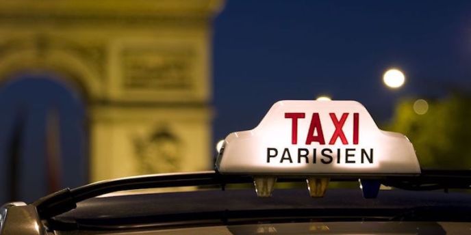 Taxi near the Arc de Triomphe. The lighted sign indicates the cab in available