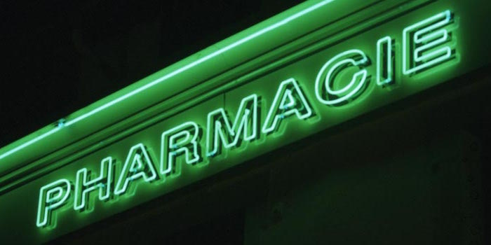 A lighted pharmacie sign on a Paris drugstore