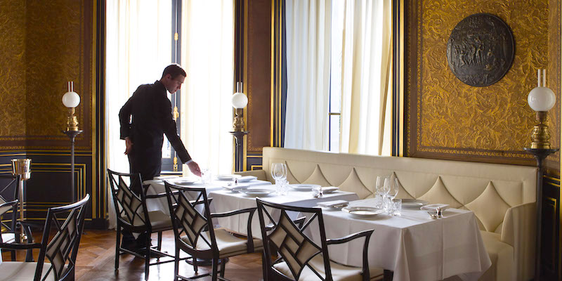 A server sets the table at Le Gabriel Restaurant