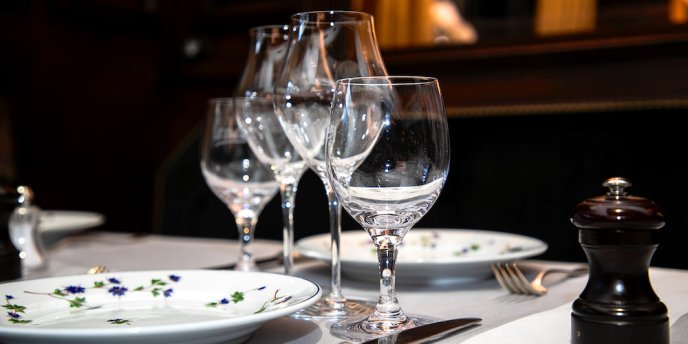 Wine glasses and elegant place settings at Le Voltaire in Paris