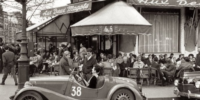 Exterior of Les Deux Magots in Paris in the 1920s with vintage roadster