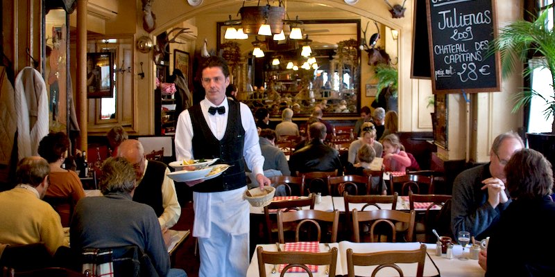 Waiters and diners at Brasserie Ile St Louis in Paris in 2012