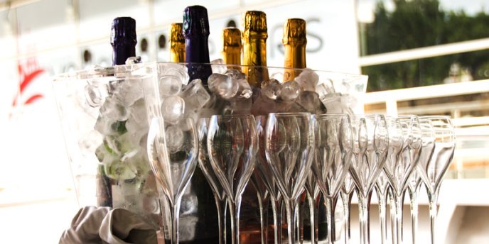 A bucket with ice and numerous champagne bottle on a Seine River Champagne Cruise