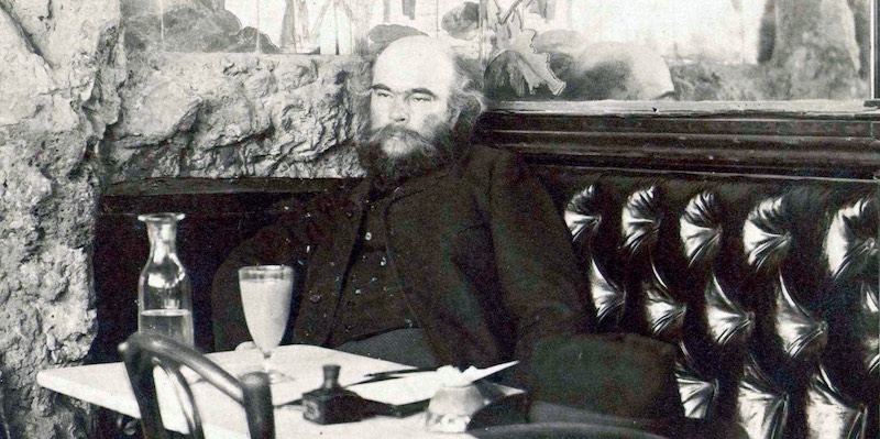 19th century photo of Frenc poet Paul Verlaine sitting in a bar in Paris