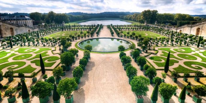 A view of the gardens of Versailles, with the round pond