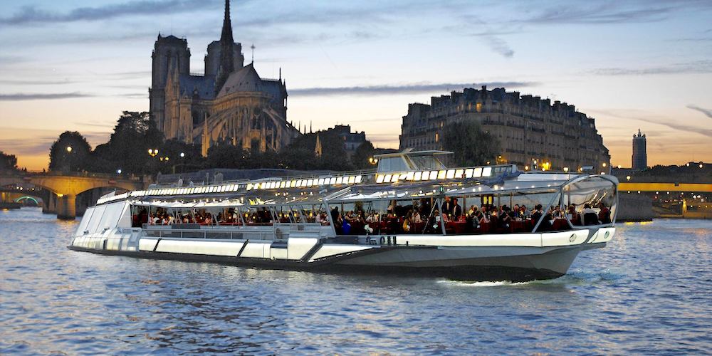 The Bateaux Mouches boat sails past Notre Dame on a Valentines Day dinner cruise.