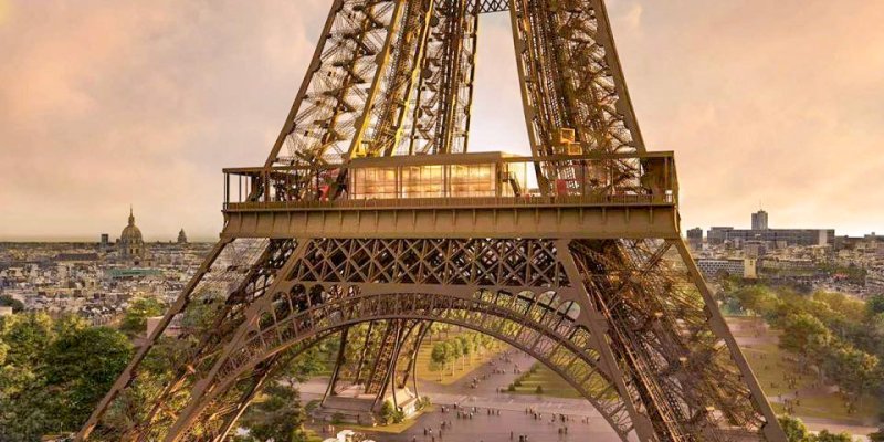 Close up of The first level of the  Eiffel Tower with softer, pink light in the sky