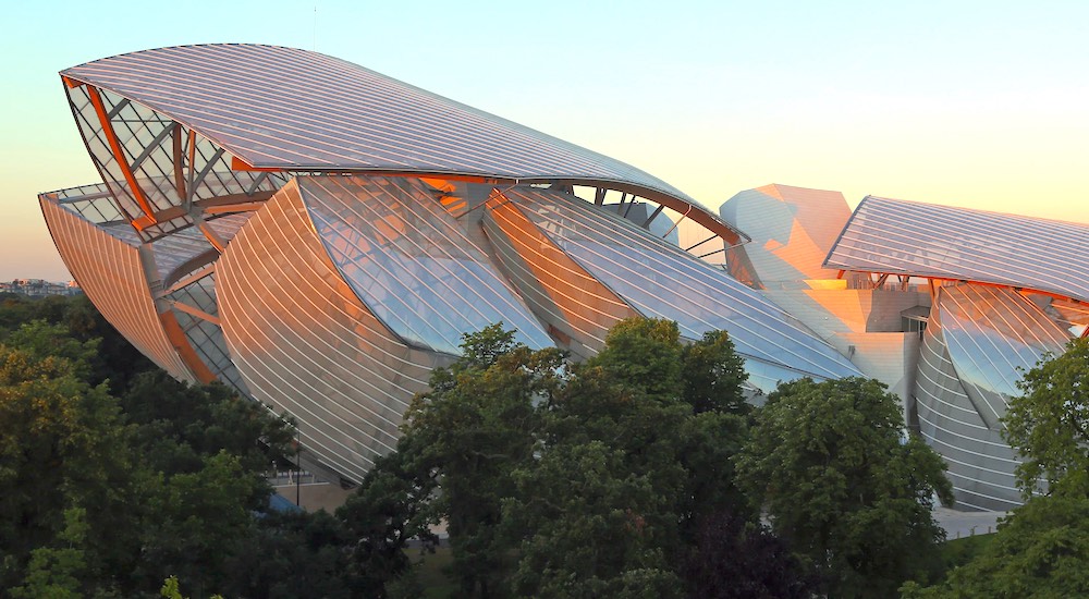 The multiple roofs of the Fondation Louis Vuitton looking like so many sails in the setting sun