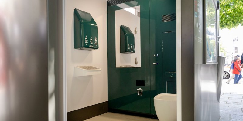 The interior of the free public washroon in Paris, in green and white.