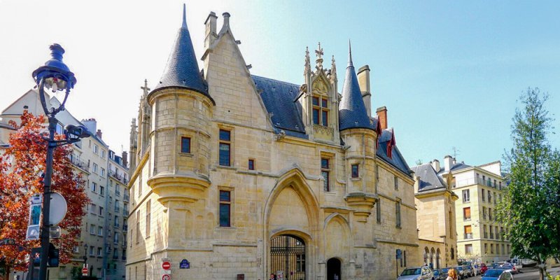 The medieval facade of Hotel de Sens with turrets and gothic decoration.