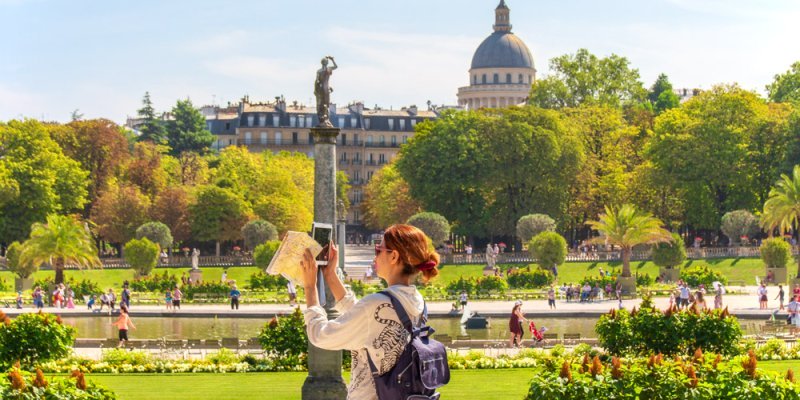 Jardin de Luxembourg on a leisurely day in Paris, with the dome of the Pantheon in the distance