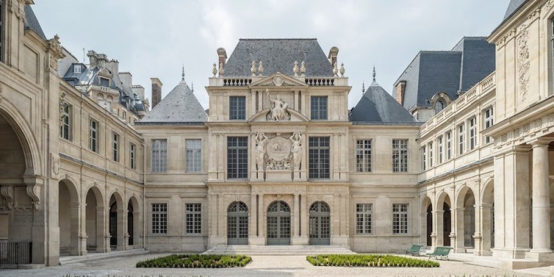 A Courtyard at Musee Carnavalet with an imposing facade and collonades