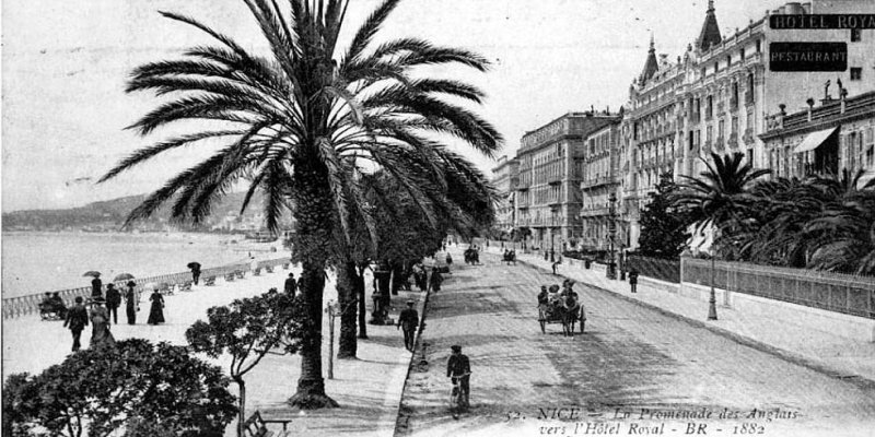 Promenade des Anglais in Nice in a black and white photo from 1882 showing a bicycle and horse-and-carriage