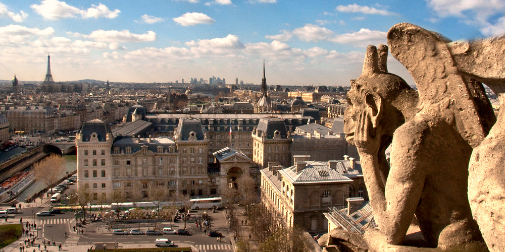 A gargole on the Notre Dame bell towers overlooking Paris