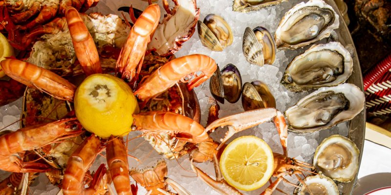 Seafood platter featuring shrimp and oysters, at Au Pied de Cochon