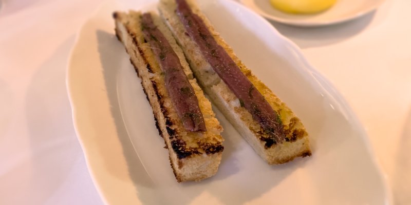 A course of anchovy paste on toast at restaurant Laurent Paris in 2024