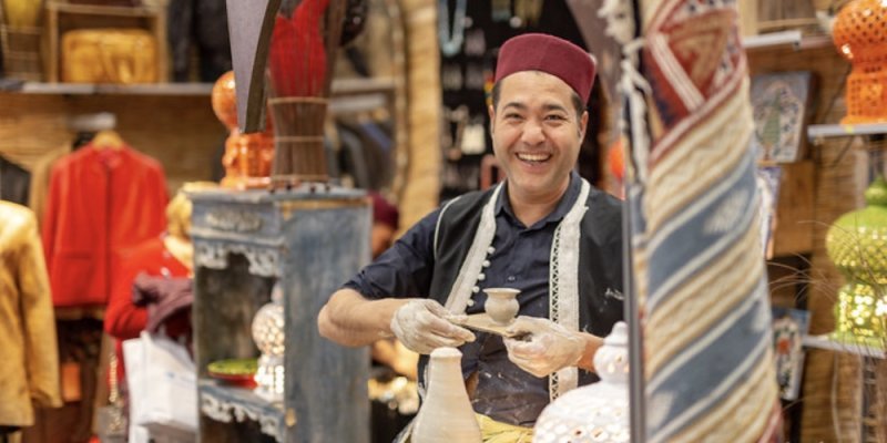 A potter exhibiting his wares at Salon du Tourisme