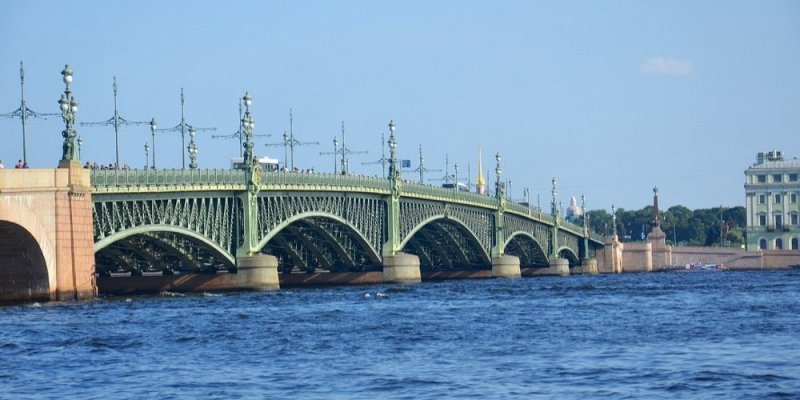 St Peterburg's Trinity Bridge with its green metal girders above the blue water of the Neva river 