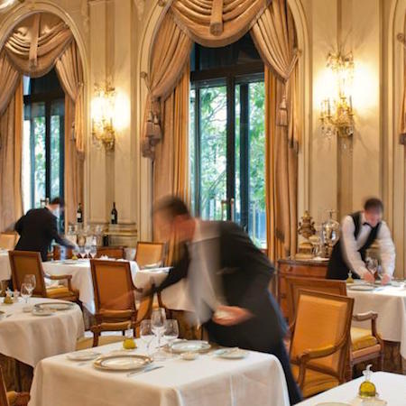 Servers preparing the table for guests at the George V Hotel Restaurant in Paris