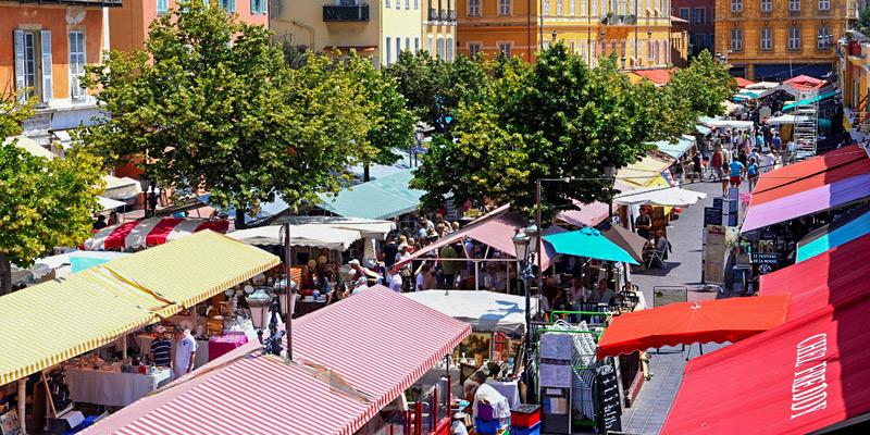 Cours Saleya Market in Nice, France, with colorful awnings shading the booths