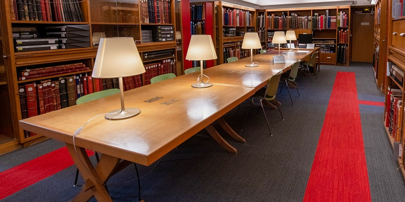 A long table surrounded by shelves inside the Bibliothèque Forney